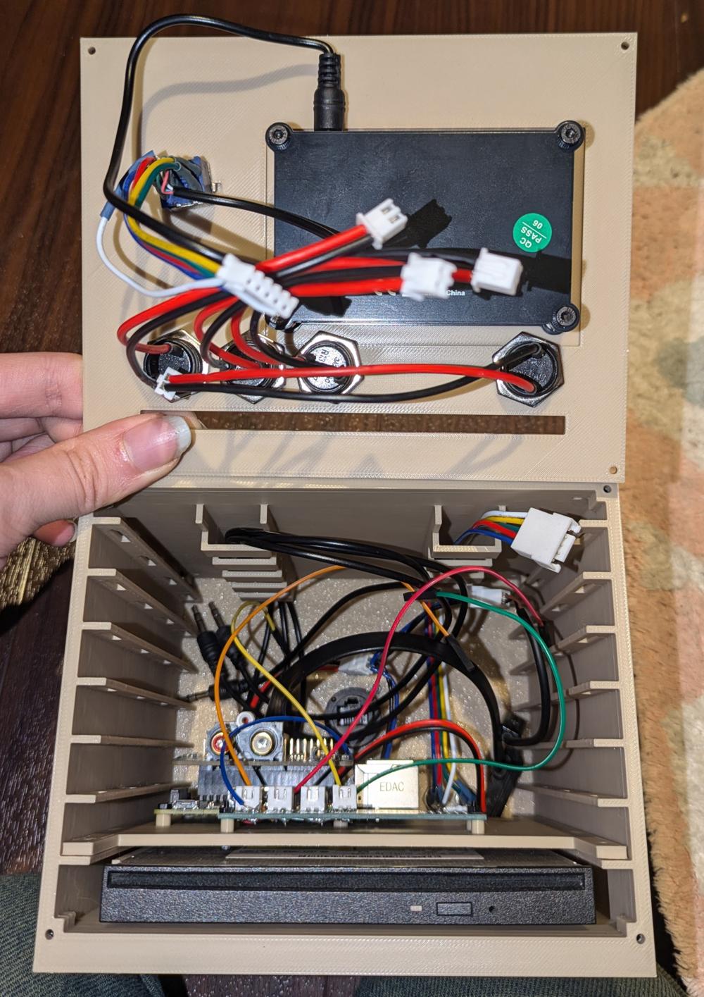 The inside of the cd player. Unplugged wires of many kinds are loosely floating around everywhere.